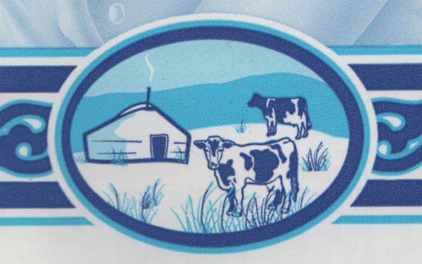 Close-up from a box of APU brand UHT milk, showing two cows and a Mongolian yurt