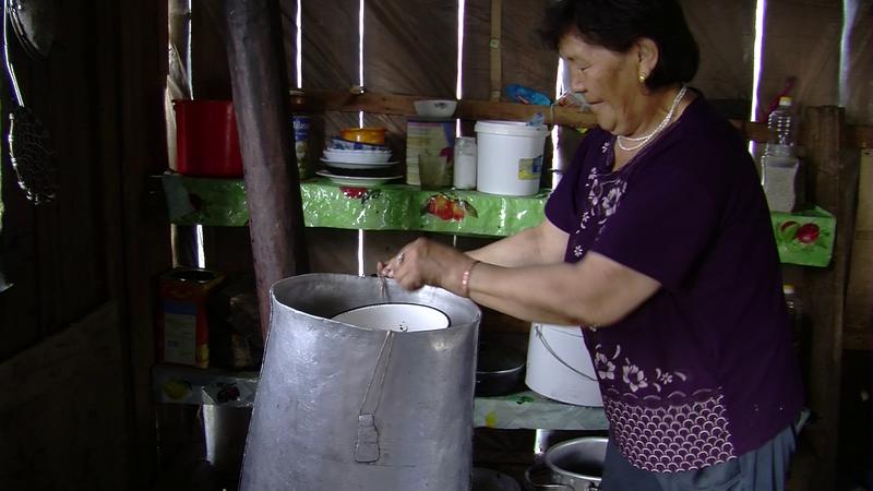 Woman setting up a still for distilling milk liquor