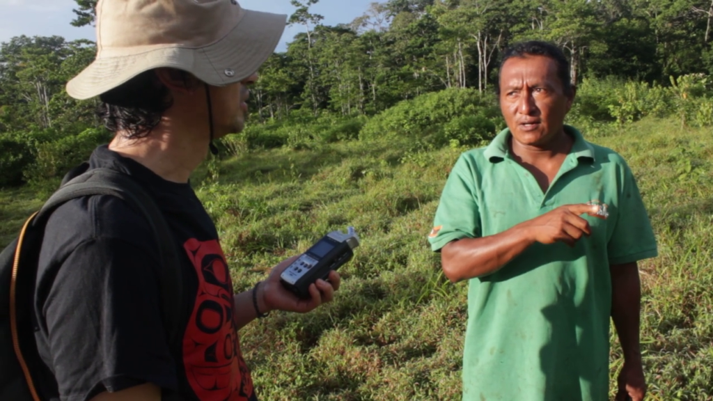 Still image of a researcher from the University of Winnipeg speaking with an Indigenous resident of a community on the Caribbean Coast of Nicaragua.
